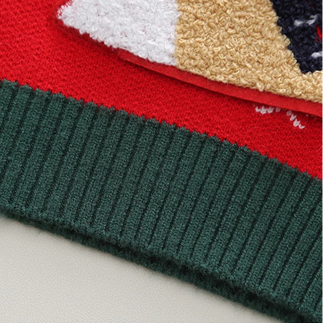 Close-up of a knitted fabric with red, green, and beige colors on a white background