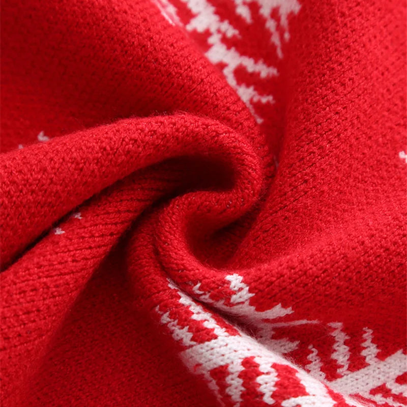 Close-up of kids Christmas red jumper with white pattern and Christmas-themed design.