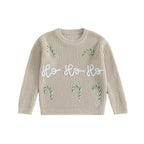 Beige christmas jumper with candy cane designs and 'Ho Ho Ho' text on a white background