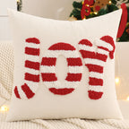 Decorative pillow with 'JOY' and candy cane designs in red and white on a neutral background.