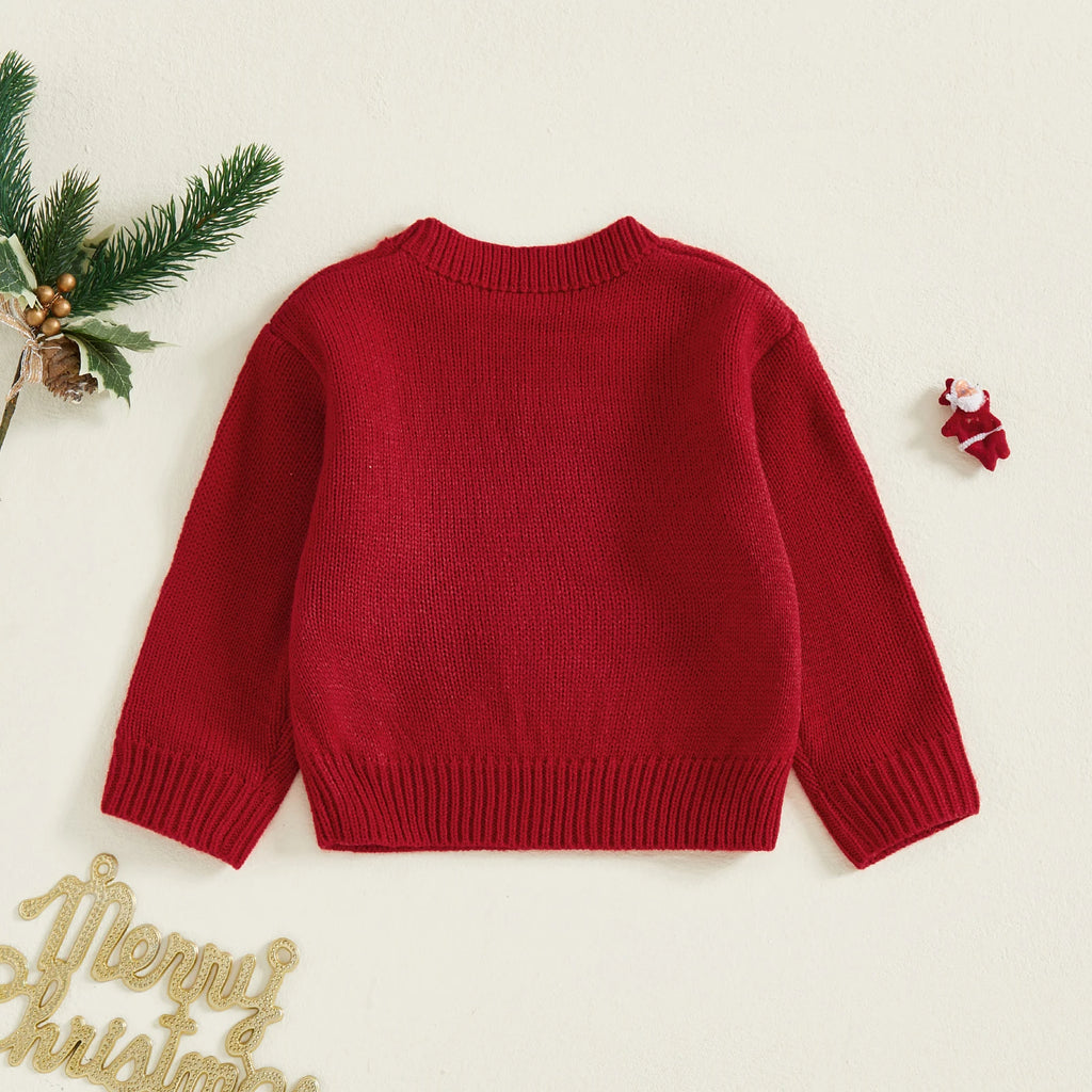 Red sweater on a white background with Christmas decorations