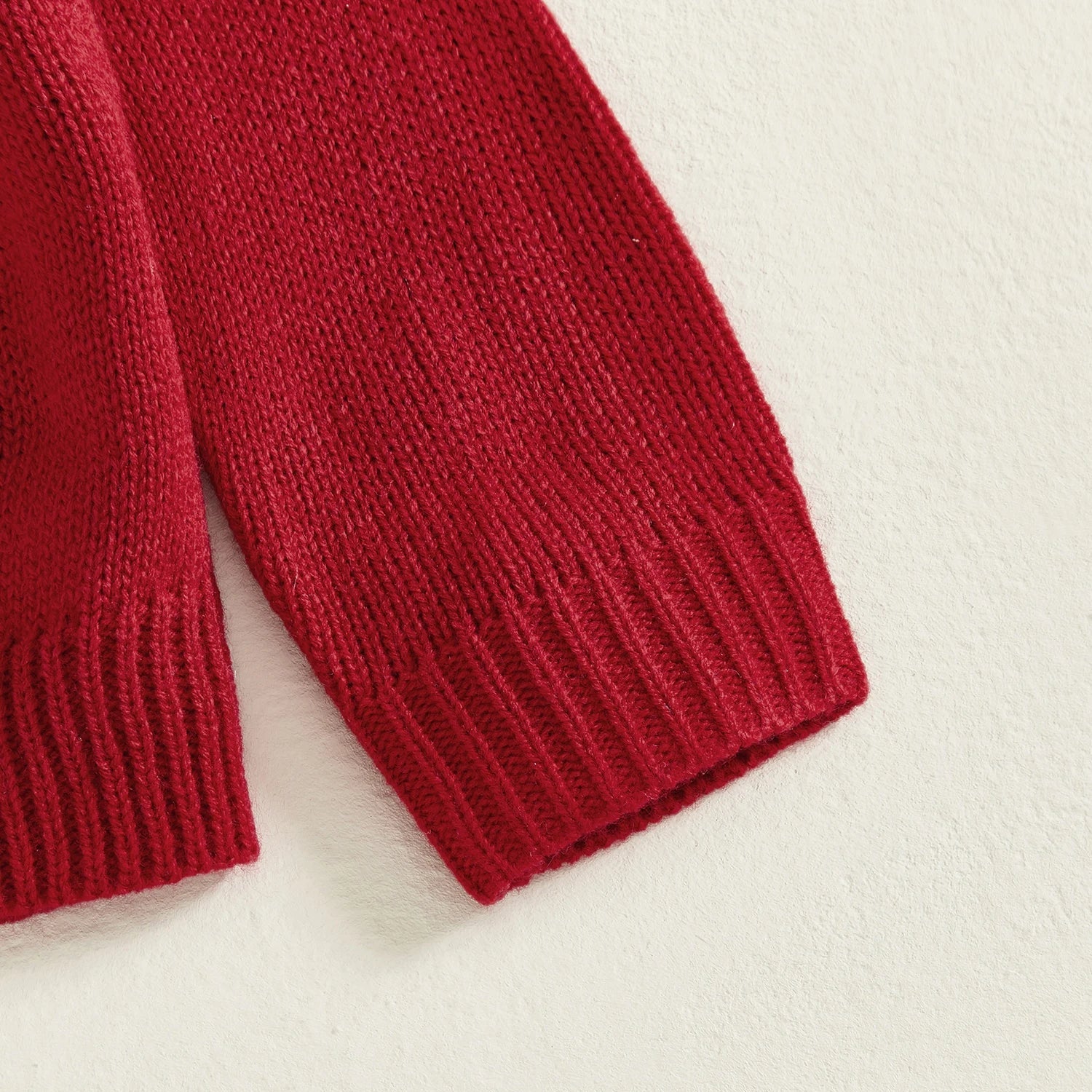 Close-up of a red knitted sleeve on a light background