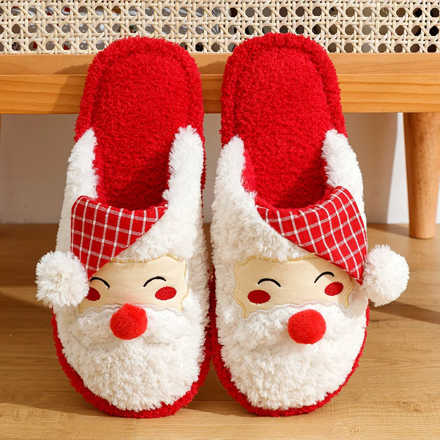 Red and white Santa Claus slippers on a wooden floor.
