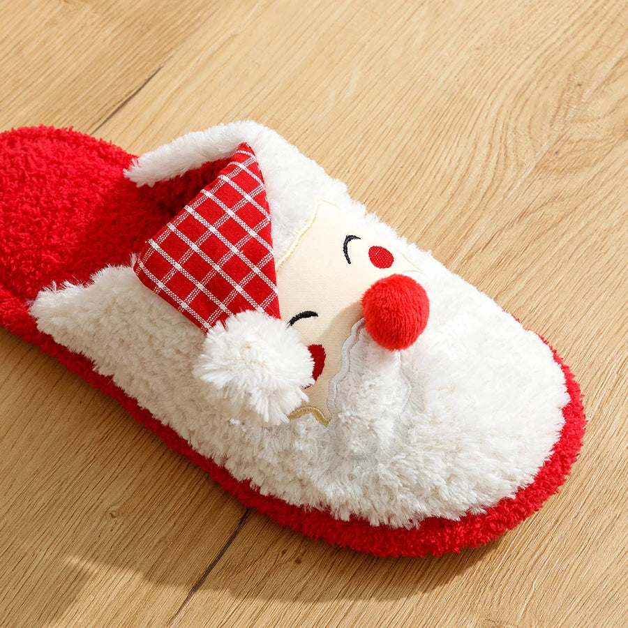 Red and white slippers with a cartoon face on a wooden floor