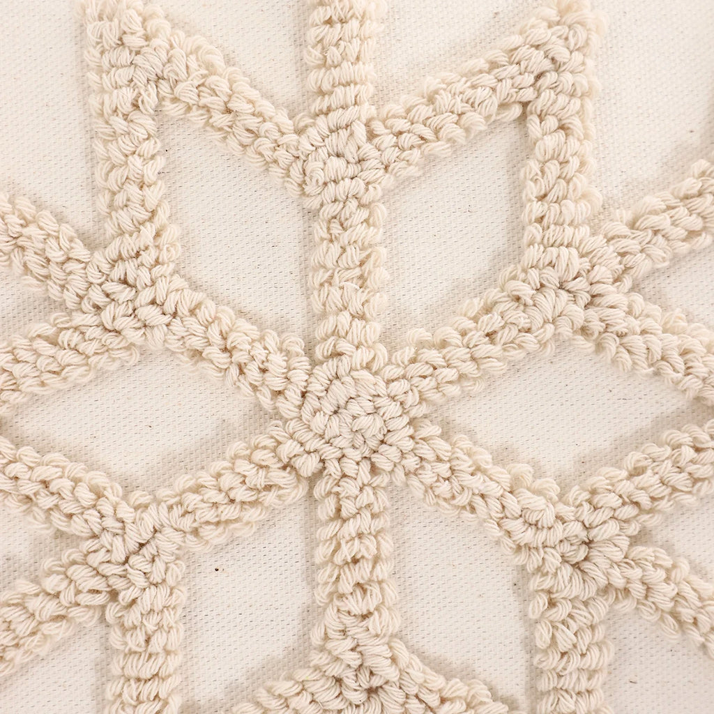 Close-up of a textured beige fabric with a geometric pattern